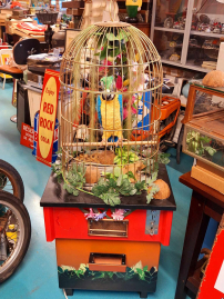 Pratende papegaai in een koperen kooi🦜