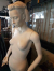 Mannequin woman on glass base and with a stylized head.